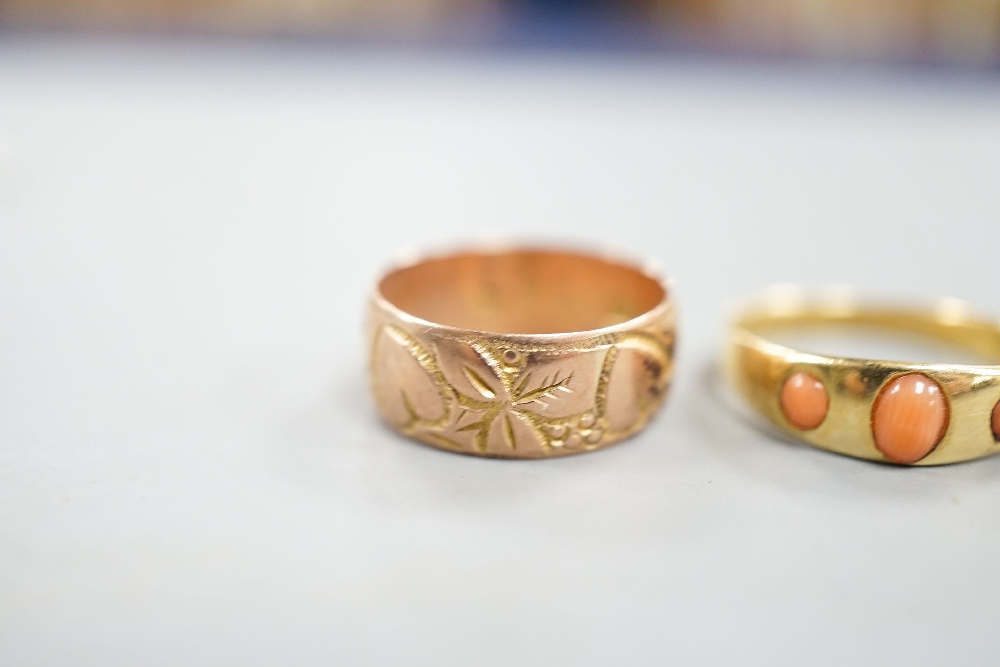 An early 20th century 18ct gold and gypsy set three stone coral ring, size P/Q, a similar sapphire and diamond set triple cluster ring, 5.5 grams, two similar 9ct gold rings, 7.7 grams and a yellow meta, foil backed amet